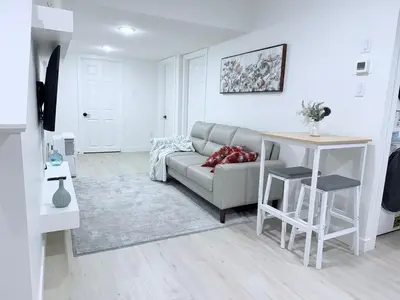 a living room with a couch and a table at Cozy 2BR Basement Rosenthal Stay by WEM with private entrance in Edmonton