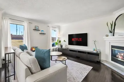 a living room with a couch and a tv at Cozy Modern Pet Friendly Homes in Calgary