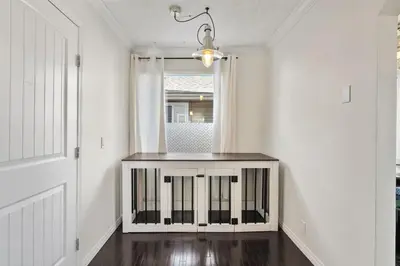 a white room with a table with a window at Cozy Modern Pet Friendly Homes in Calgary