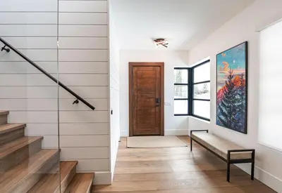 a hallway with stairs and a painting on the wall at Sitka Spruce Mountain Chalet in Revelstoke