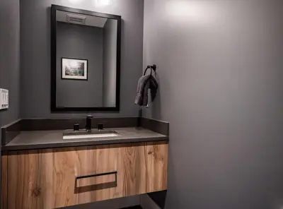 a bathroom with a sink and a mirror at Sitka Spruce Mountain Chalet in Revelstoke