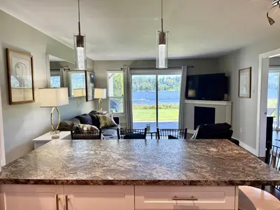 a kitchen and living room with a large counter top at Lakefront Suite on Shawnigan Lake in Shawnigan Lake