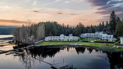 a large house on the shore of a body of water at Lakefront Suite on Shawnigan Lake in Shawnigan Lake