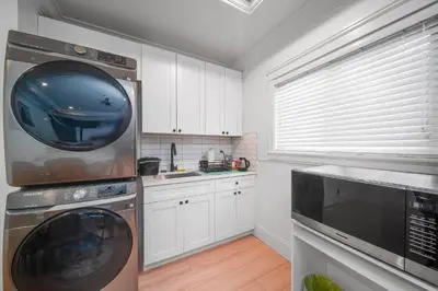 a kitchen with a washer and dryer in at Guest suite in Richmond in Richmond