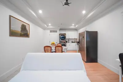 a kitchen with a white table and a refrigerator at Guest suite in Richmond in Richmond