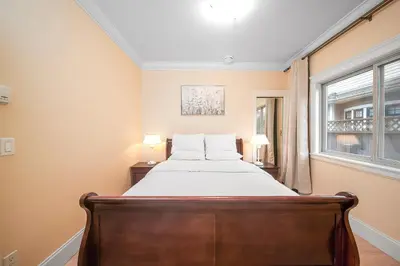 a bedroom with a bed and a window at Guest suite in Richmond in Richmond