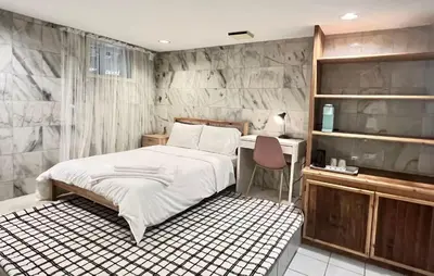 a bedroom with a bed and a desk in it at Luxurious and quiet room in Vancouver's West End in Vancouver