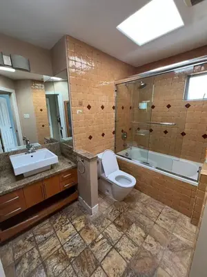 a bathroom with a toilet and a tub and a sink at Luxurious and quiet room in Vancouver's West End in Vancouver