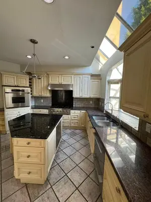 a kitchen with white cabinets and black counter tops at Luxurious and quiet room in Vancouver's West End in Vancouver