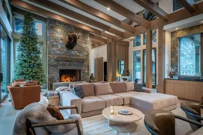 a living room with a couch and a fireplace at Mountain Lake Luxury Ski Chalet in Revelstoke