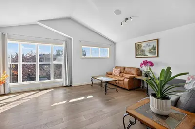 a living room with a couch and a table at Luxury Home with 5 BR, 9 Beds, 4BA, sleep 12, AC, Crib in Calgary