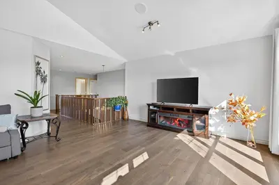 a living room with a fireplace and a tv at Luxury Home with 5 BR, 9 Beds, 4BA, sleep 12, AC, Crib in Calgary