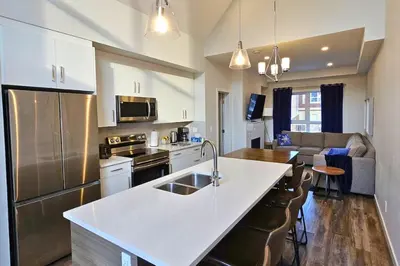 a kitchen with a white counter top in a room at Cloudline Vista 3 BdrmTownhouse with Garage managed by Little Sister Getaways in Canmore