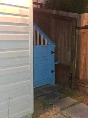 a blue door on the side of a house at Blue Villa by the Sea in Sechelt
