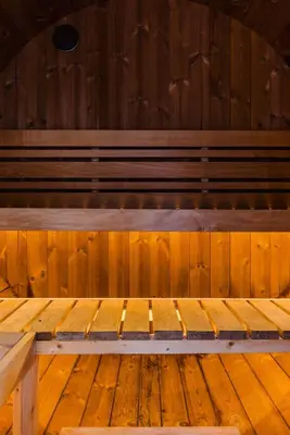 a wooden bench in a room with wooden floors at NordicSauna 3 Ensuite baths TheYellowDoorRetreat in Edmonton