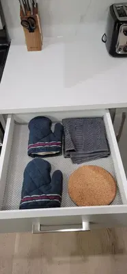 a drawer in a kitchen with mats and towels at A3 Home in Secord in Edmonton