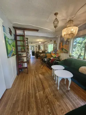 a living room with a green couch and tables at Trout House by Trout Lake in Vancouver
