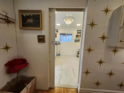 a bathroom with stars on the wall and a doorway at Garden View double room suite at Trout Lake in Vancouver