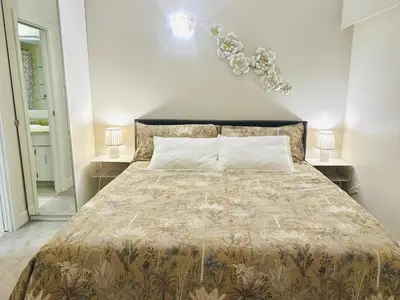 a bedroom with a large bed with two night stands at 4BR 2BA Downtown-View Cozy House with Parking, Pet-Free in Vancouver