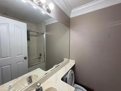 a bathroom with a sink and a mirror at Delta Guest House - Scott Rd & Rapid Transit - Airport 20 Min - Free Parking & Fast Wi-Fi in Delta