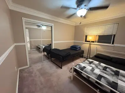 a bedroom with a bed and a mirror at Delta Guest House - Scott Rd & Rapid Transit - Airport 20 Min - Free Parking & Fast Wi-Fi in Delta