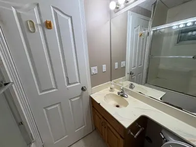 a bathroom with a sink and a mirror at Delta Guest House - Scott Rd & Rapid Transit - Airport 20 Min - Free Parking & Fast Wi-Fi in Delta