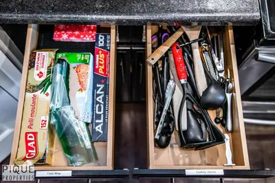 a drawer full of kitchen utensils under a counter at 5BD Jungle Oasis - HotTub - BBQ - King Bed - Games - Garage in Edmonton