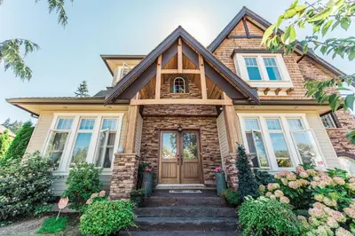 a house with a wooden door and windows at Grace Guest House in White Rock