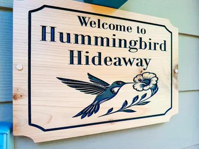a sign that reads welcome to hummingbird hidden hallway at Oceanside Resort 3 BED 2 BATH with Indoor Pool and Hot Tub in Parksville