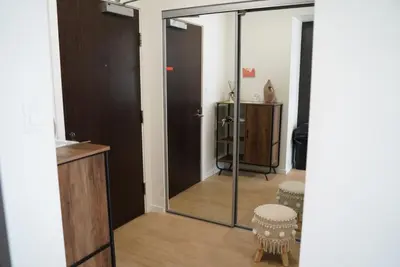 a room with a mirror and a door with a stool at Cozy Richmond Center Downtown 2B & 2B Apartment in Richmond