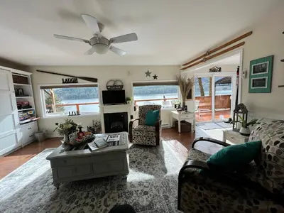 a living room with a couch and a ceiling fan at Mile 77 Cottages in Youbou