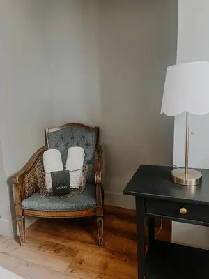a chair with two pillows and a lamp next to a table at Wilder Lodge in Fairmont Hot Springs