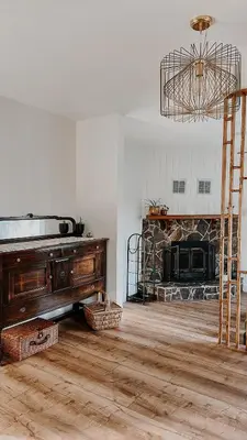 a living room with a piano and a fireplace at Wilder Lodge in Fairmont Hot Springs