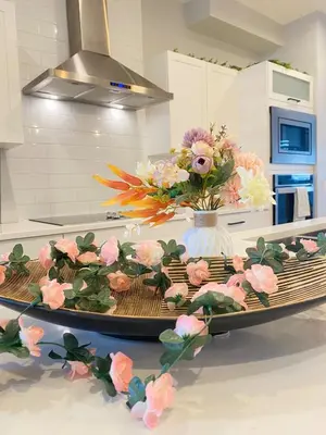 a kitchen counter with a vase of flowers on it at The Downtown Oasis - A Spacious Family Friendly 3 Bedroom House Close to Everything in Edmonton