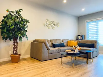 a living room with a couch and a table at The Downtown Oasis - A Spacious Family Friendly 3 Bedroom House Close to Everything in Edmonton