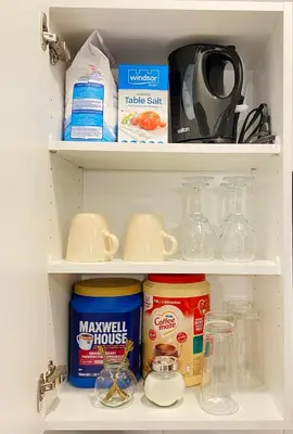 a refrigerator shelf filled with food and other kitchen items at The Private Central Edmonton Suite - Comfortable & Fully-Equipped Basement Suite in Edmonton