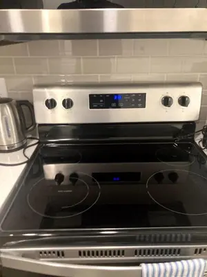 a close up of a stove top oven at Cozy 2 Bedroom Apartment in Calgary