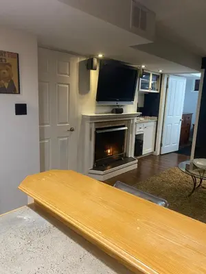 a living room with a fireplace and a flat screen tv at Your Home Away From Home in Abbotsford