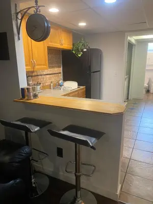 a kitchen with a counter and two bar stools at Your Home Away From Home in Abbotsford