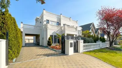 a large white house with a driveway at #3 Room in Richmond