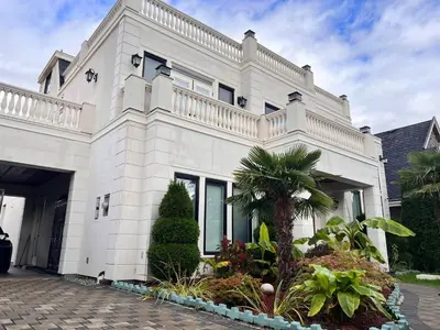 a white house with a palm tree in front of it at #3 Room in Richmond