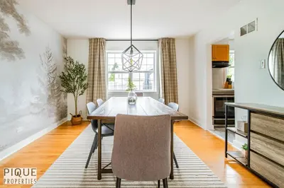 a dining room with a table and chairs at Nordic Spa Retreat - Hot Tub - King Bed - Firepit - BBQ in Edmonton