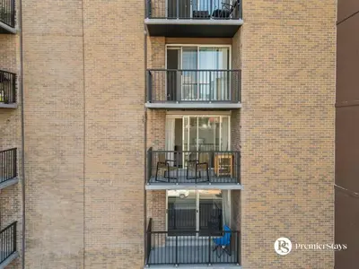 a brick building with balconies on the side of it at Downtown 17th Ave Lifestyle with Secure Parking and AC in Calgary