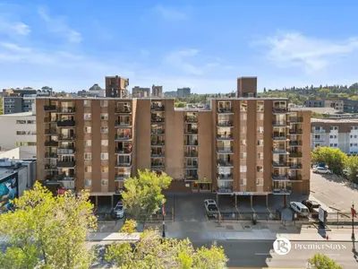 an aerial view of an apartment building in a city at Downtown 17th Ave Lifestyle with Secure Parking and AC in Calgary