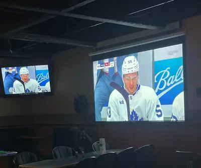 two tv screens with a hockey player on them at Big Horn motor Inn in Grande Cache