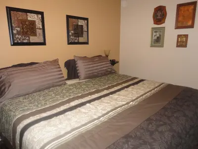 a bed in a bedroom with pictures on the wall at Vintage Merlot Bed and Breakfast in Oliver