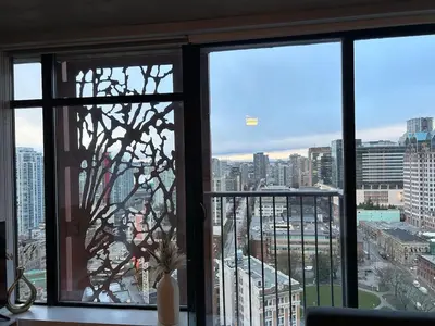 a window with a view of a city at Cozy Gastown condo with a view! in Vancouver