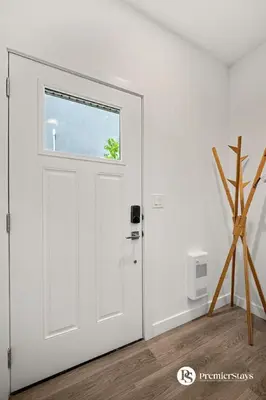 a white door in a white room with a window at Executive Suite with King Bed Garage AC Free Banff Pass 65 Inch TV in Calgary