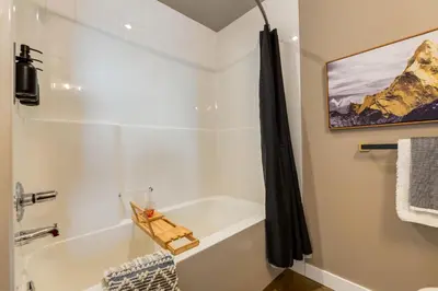 a bathroom with a white tub and a shower at Summit Mountain & Skyline Views Beltline in Calgary