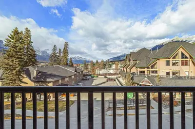 a view from the balcony of a house at Peak n Plunge Insane MTN View Pool n Hot Tub K201 in Canmore